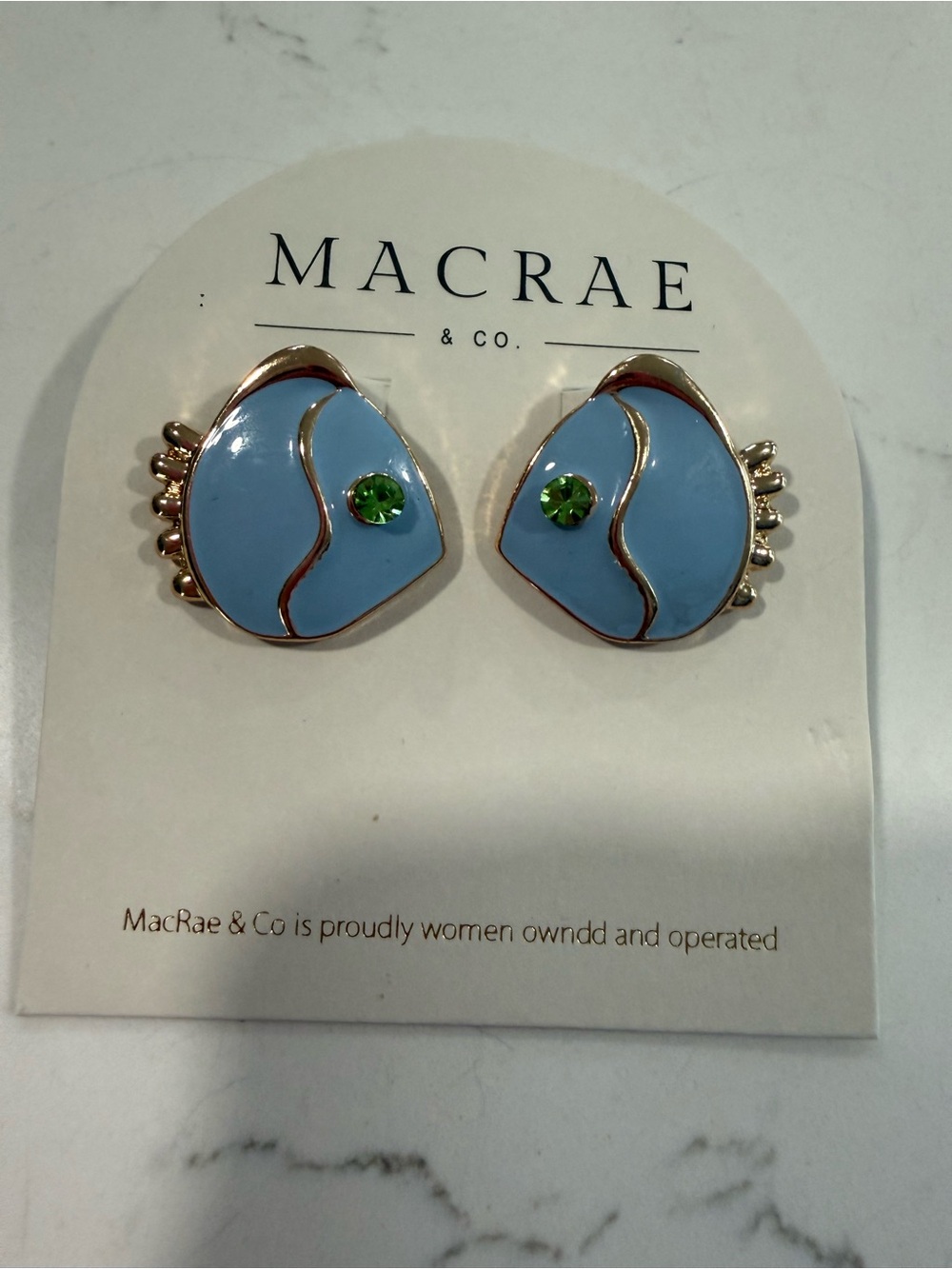 Blue enamel fish with green crystal eyes